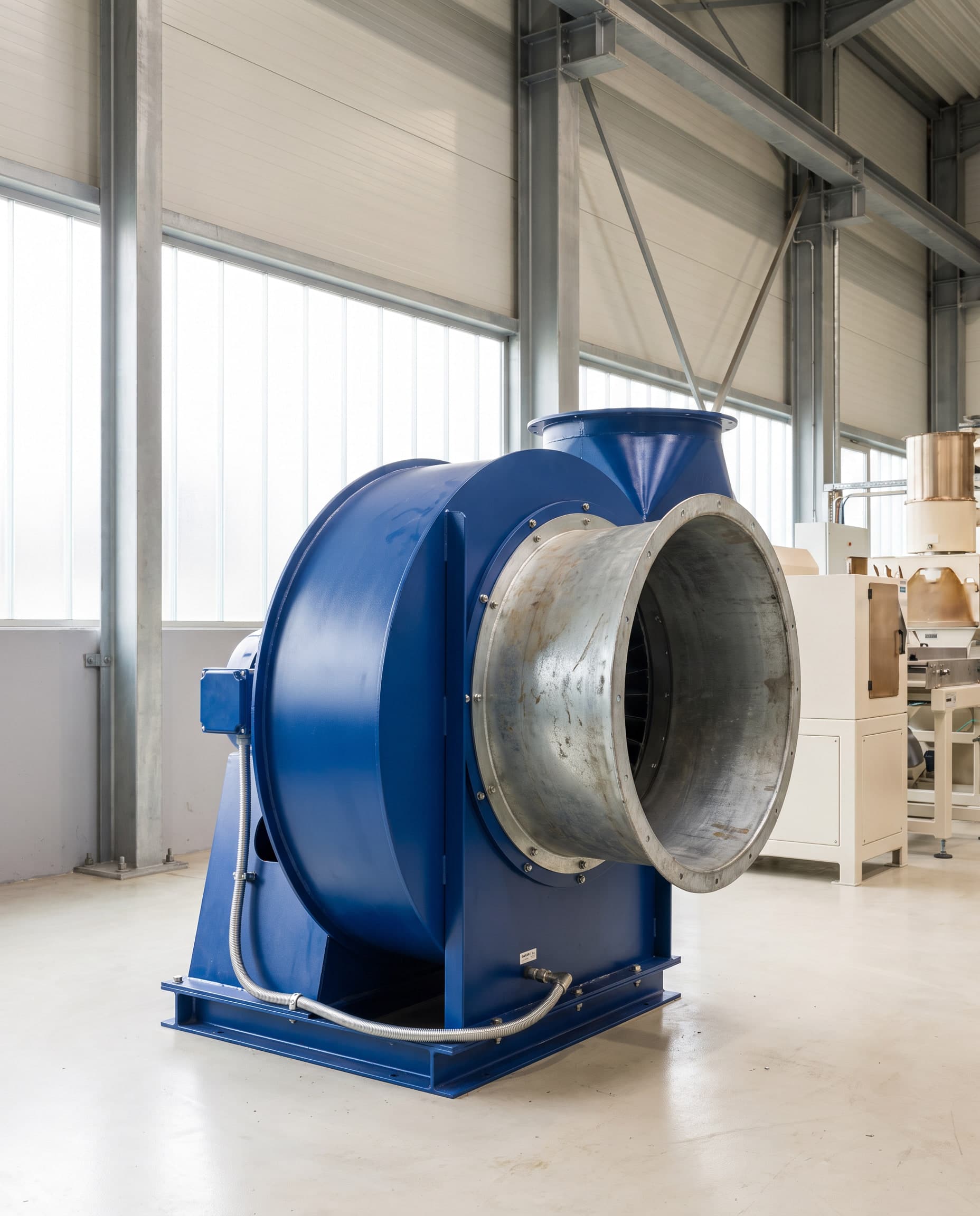 Industrial centrifugal ventilation fan with a cobalt-blue housing