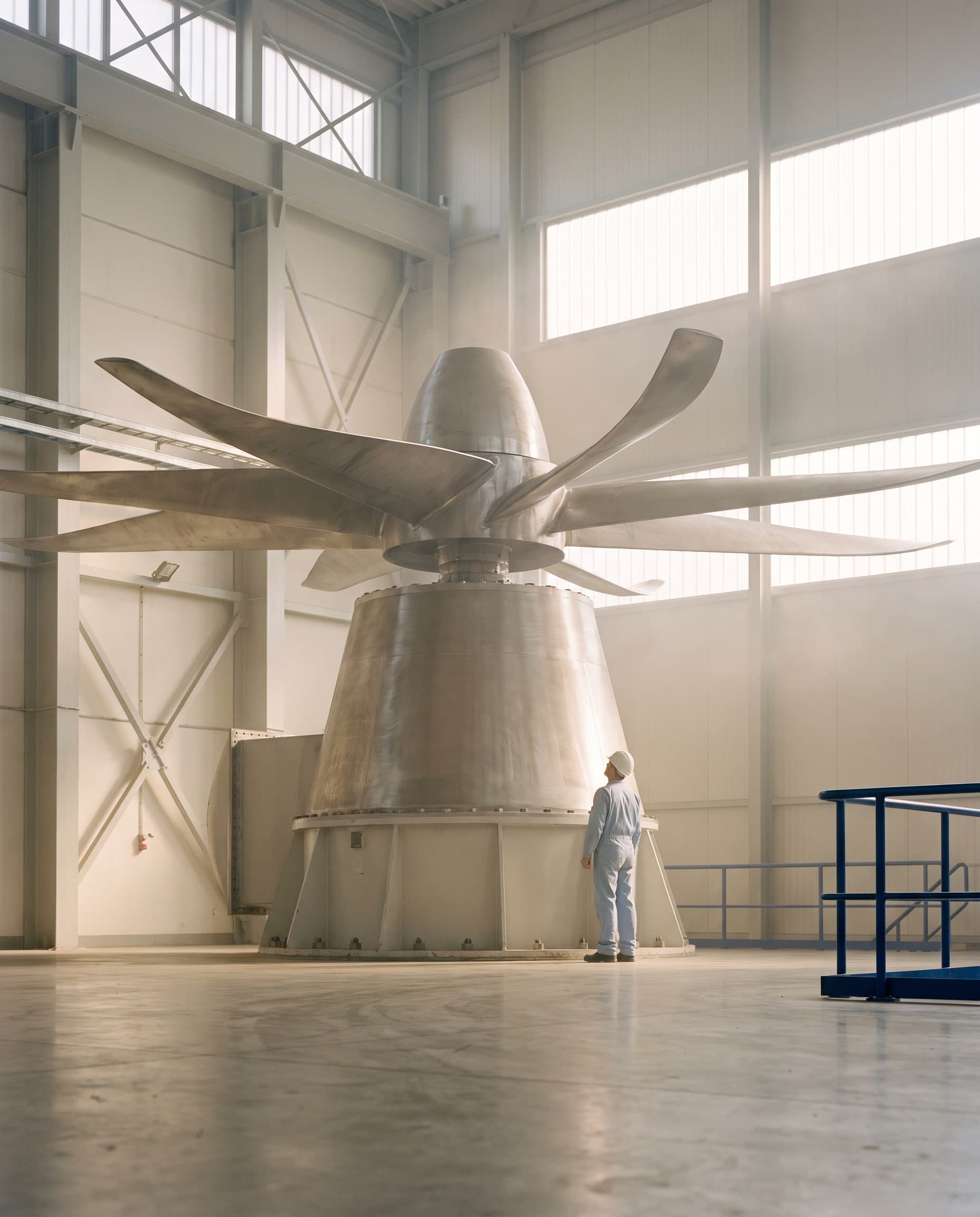 Large axial fan rotor inside an industrial plant hall